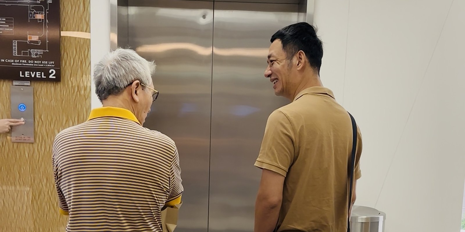 Đi cùng người bệnh trong khu vực thang máy của bệnh viện ở Singapore